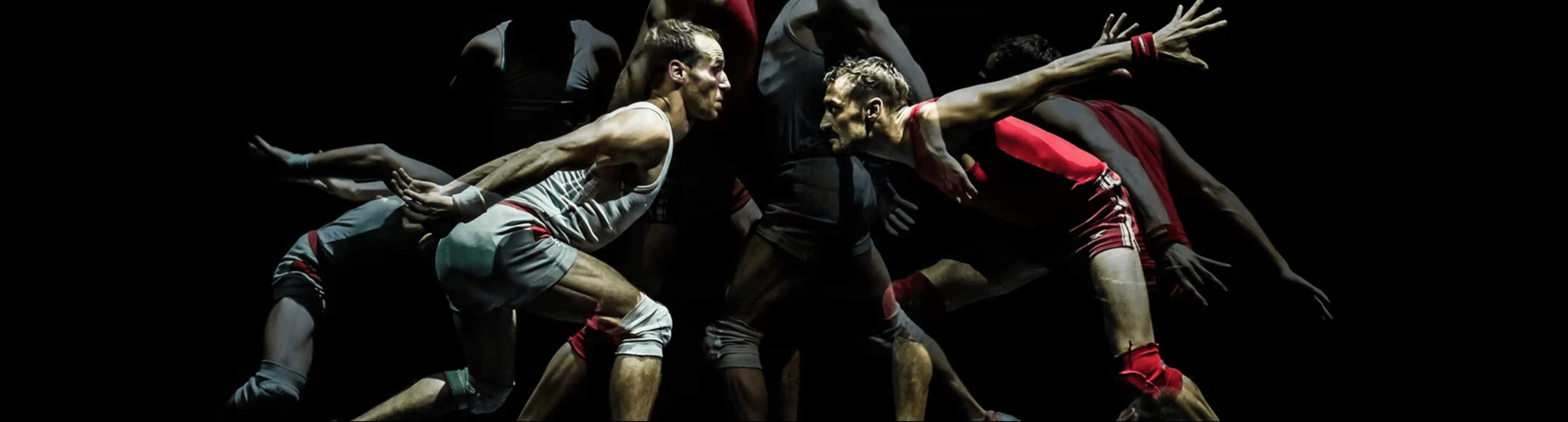 Two men in an empty locker room square off in confrontation.